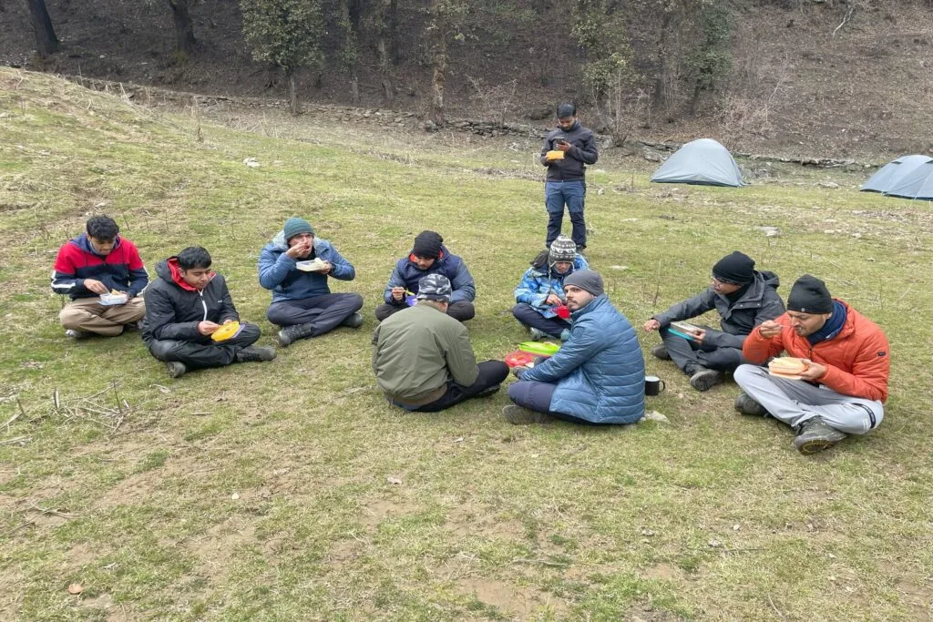 ISB students enjoy a well-deserved lunch break amidst the majestic Himalayas.