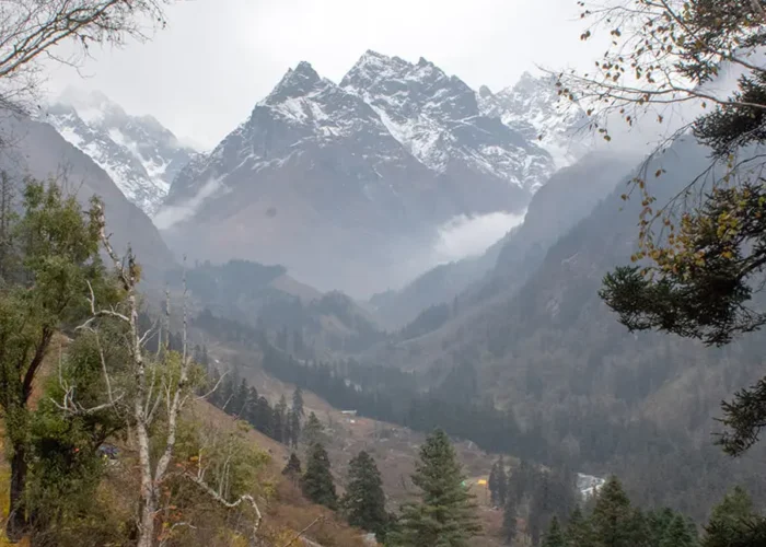 Towering snow peaks command a breath-taking view over the valley on Har Ki Dun Trek in March