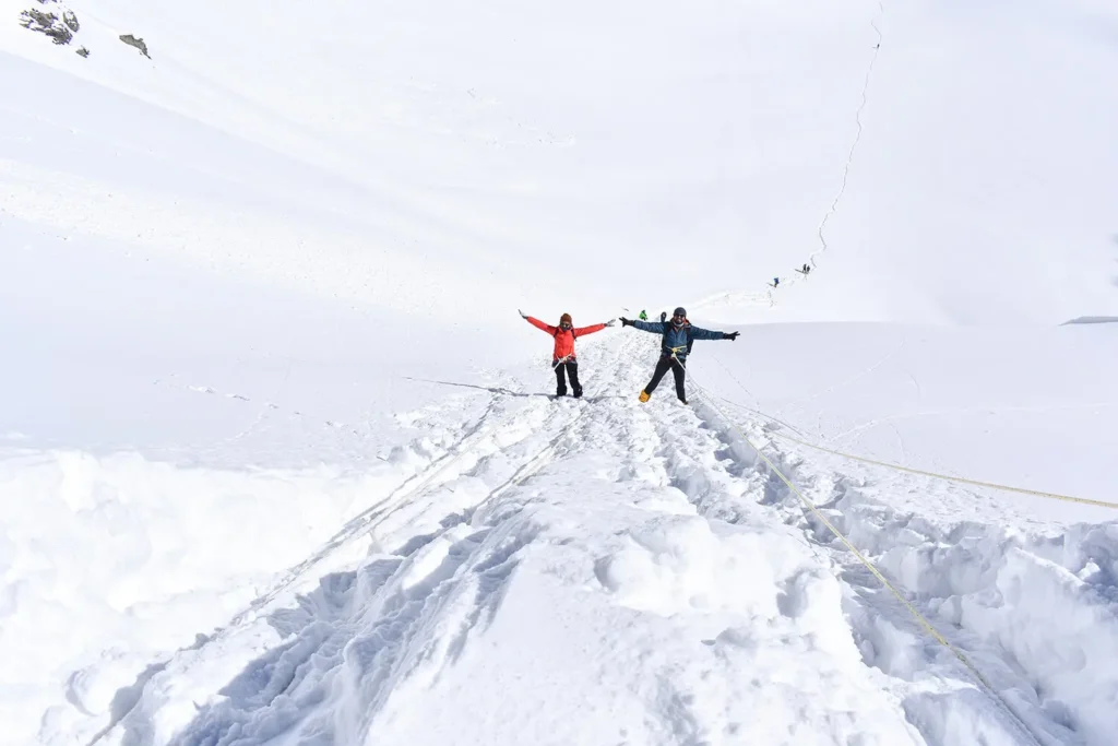 Trekkers rappel down the first 100 metres of an almost vertical snow wall of Buran Pass.