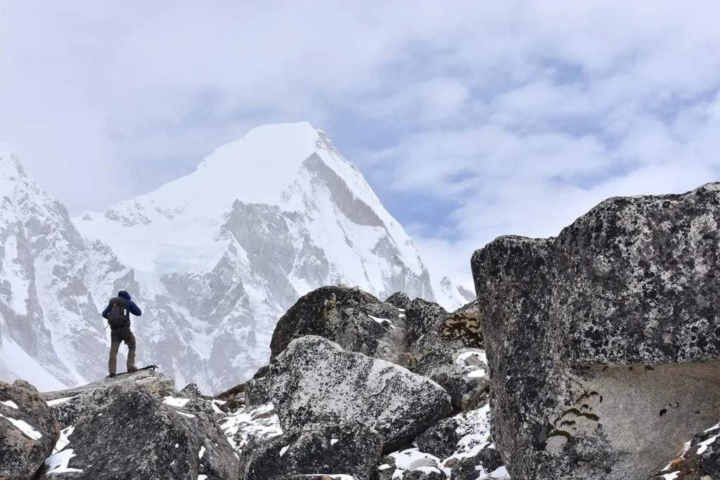 An adventurous trekker mesmerized by the grandeur of Mt Everest on Everest Base Camp Trek in Nepal in winters