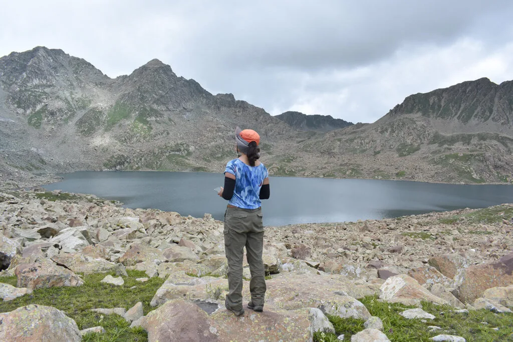 The woman trekker charted her course, her eyes scanning the horizon for landmarks.