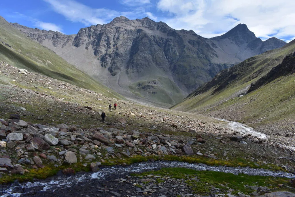 Trekkers threads its way across the high-altitude terrain of the Pin Bhaba pass trek in June