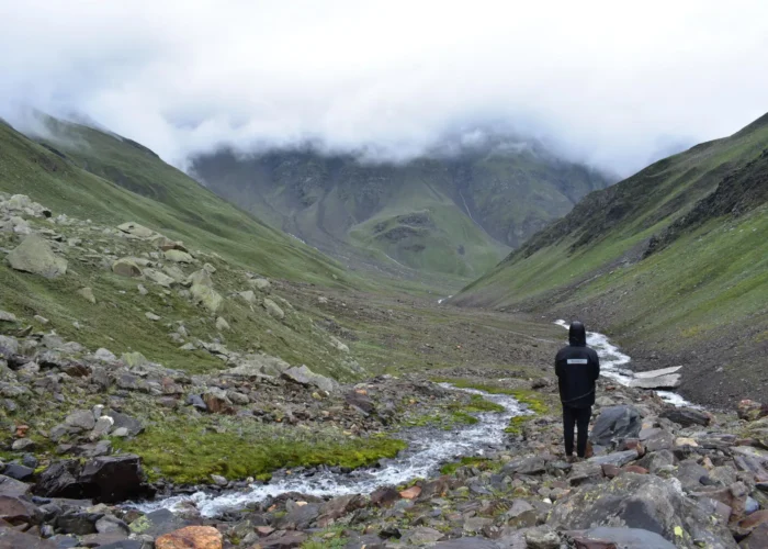 A trekker immerses in a breathtaking landscapes on Pin Bhaba Pass Trek.