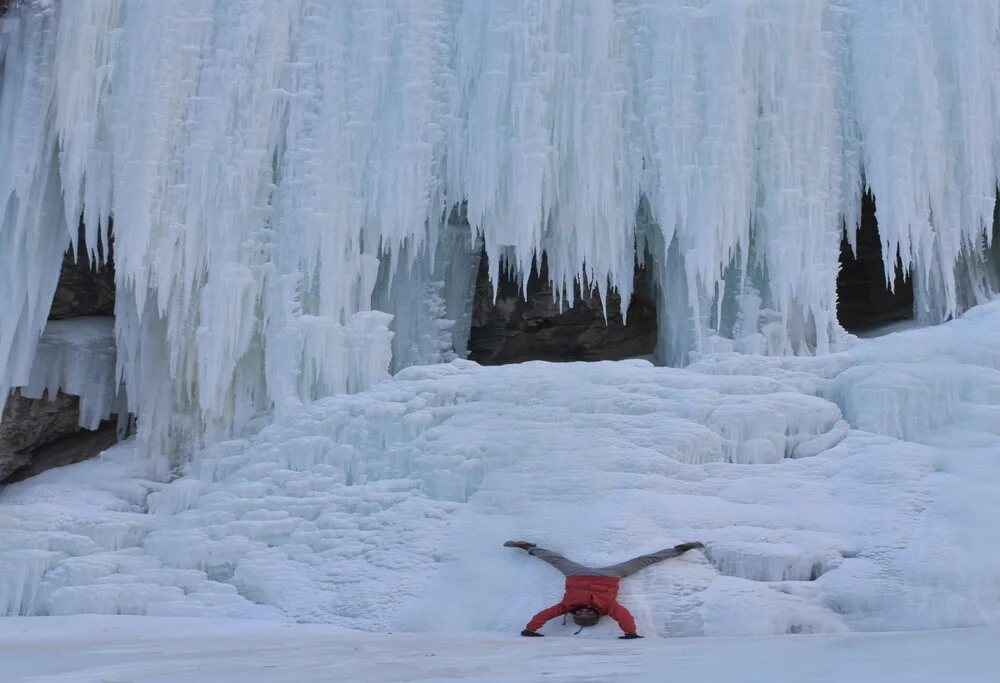 Trekker try to capture the beauty of the frozen Nerak waterfall upside down on Chadar Trek.